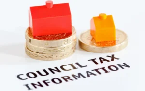 Small-red-and-orange-house-figures-on-coins-with-the-text-COUNCIL-TAX-INFORMATION-beneath-focusing-on-council-tax-premiums