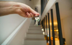 Hand-holding-keys-to-a-property,-related-to-What-Does-PCM-Mean-Rent