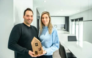 property-owner-holding-house-model-inside-modern-rental-home