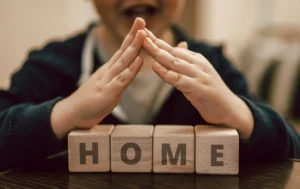 A-child-making-a-'home'-gesture-symbolizing-the-safe-space-provided-by-a-Children's-Care-Home