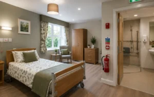 CQC-Care-Home-Inspection-showing-a-compliant-care-home-bedroom-with-accessible-features-en-suite-wet-room-fire-safety-equipment-and-modern-furnishings