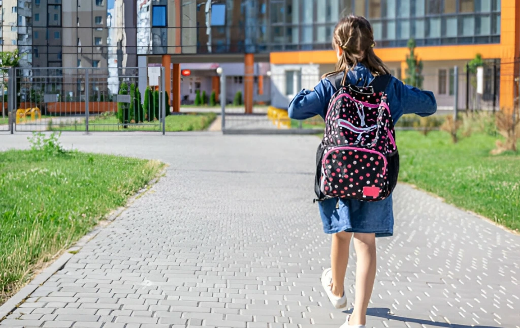 little-girl-goes-to-school-with-a-backpack-back-view