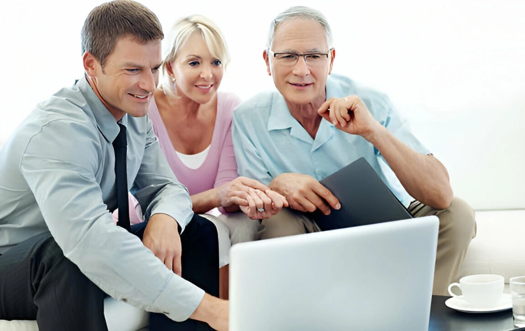 A-group-of-people-looking-at-a-laptop-discussing-portfolio-services