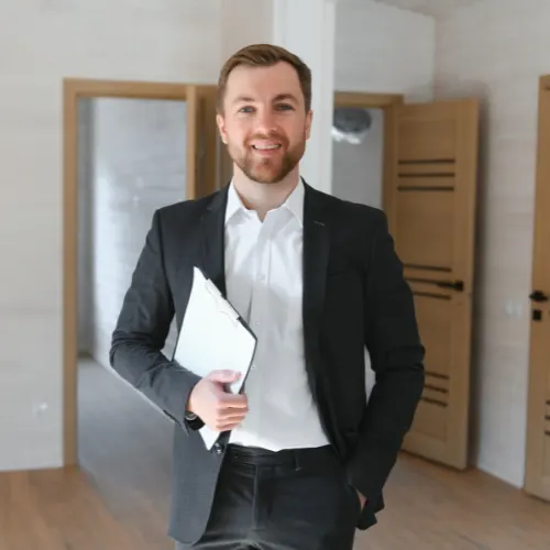 A-man-holding-a-clipboard-and-smiling-in-a-room-with-open-doors-Property-lease