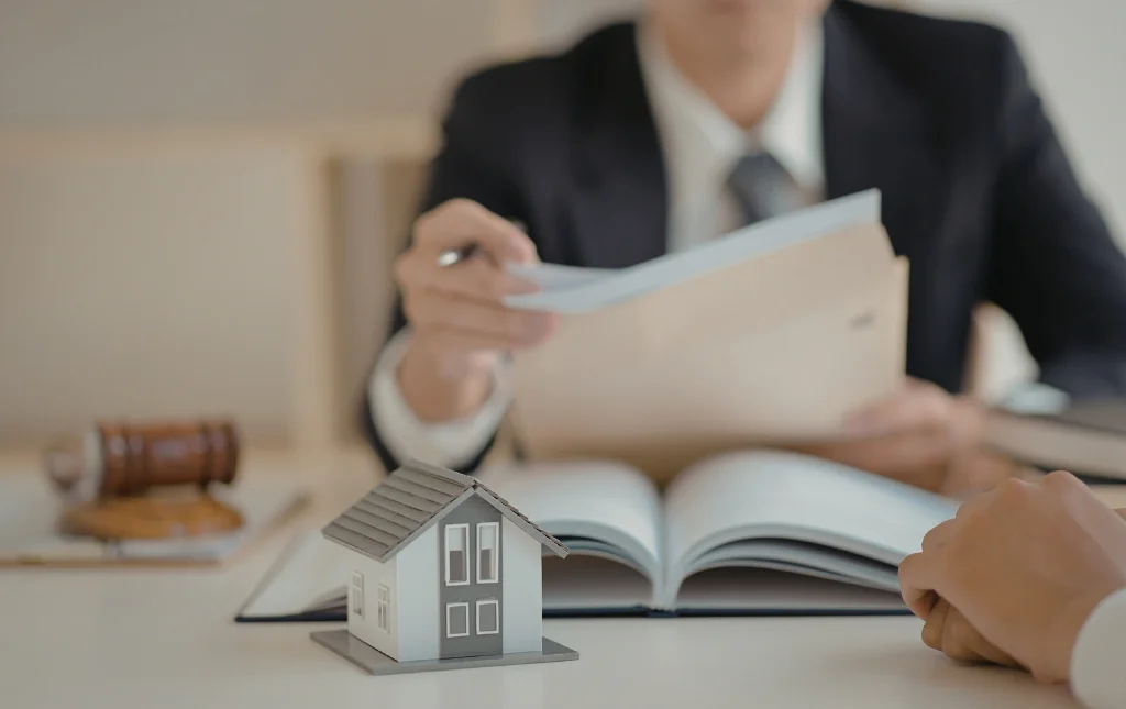 C2-Conversions-Lawyer-holding-document-with-miniature-house
