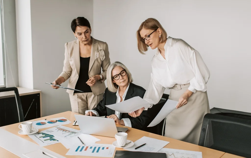 C2-Conversions-Three-women-in-office-working-and-discussing