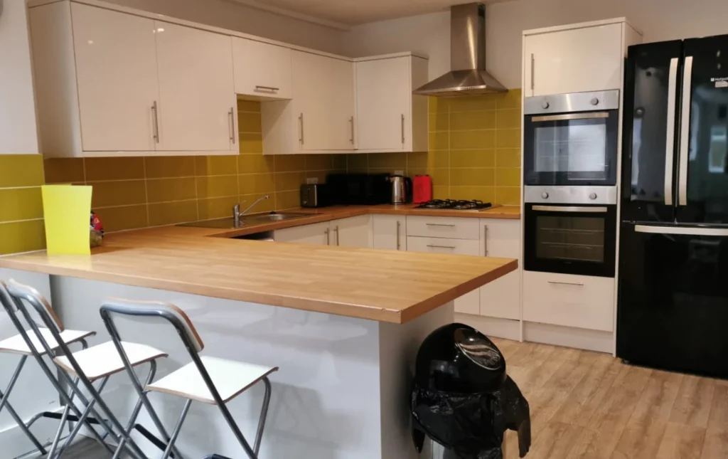 Teignmouth-Road-modern-kitchen-with-white-cabinets-and-breakfast-bar